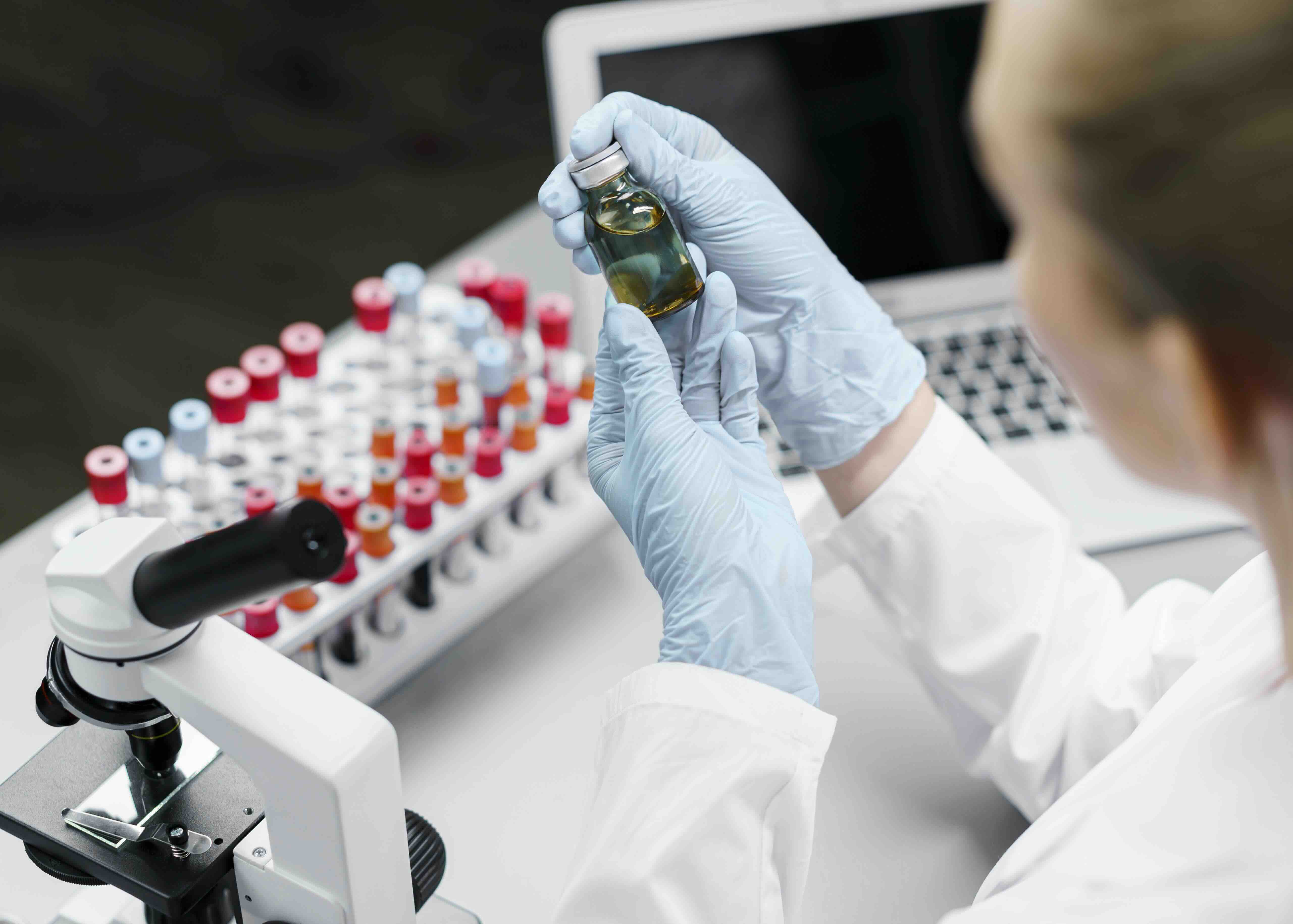 female-researcher-laboratory-with-test-tubes-vaccine-bottle.jpeg